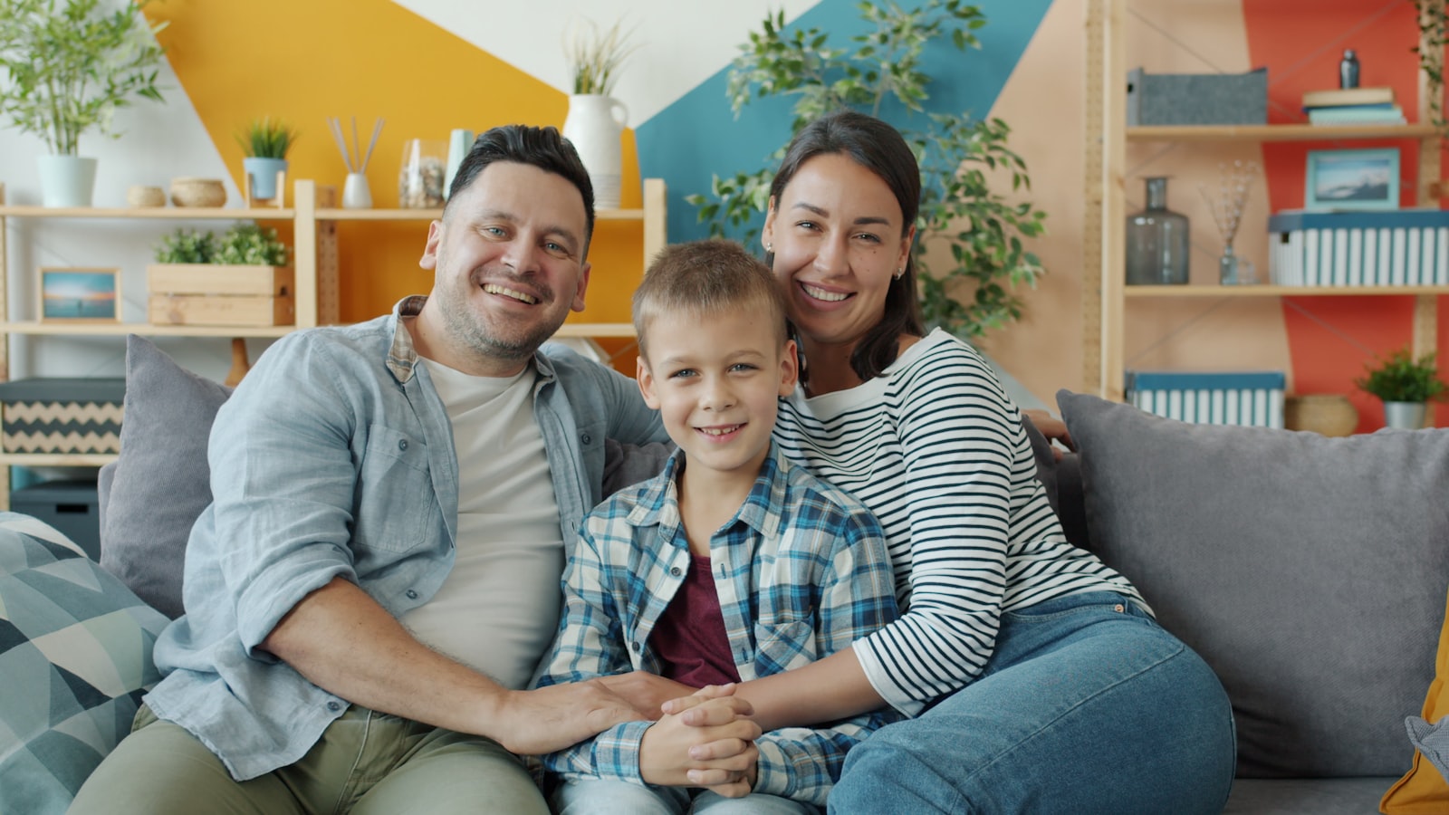 Happy family relaxing together on a sofa at home
