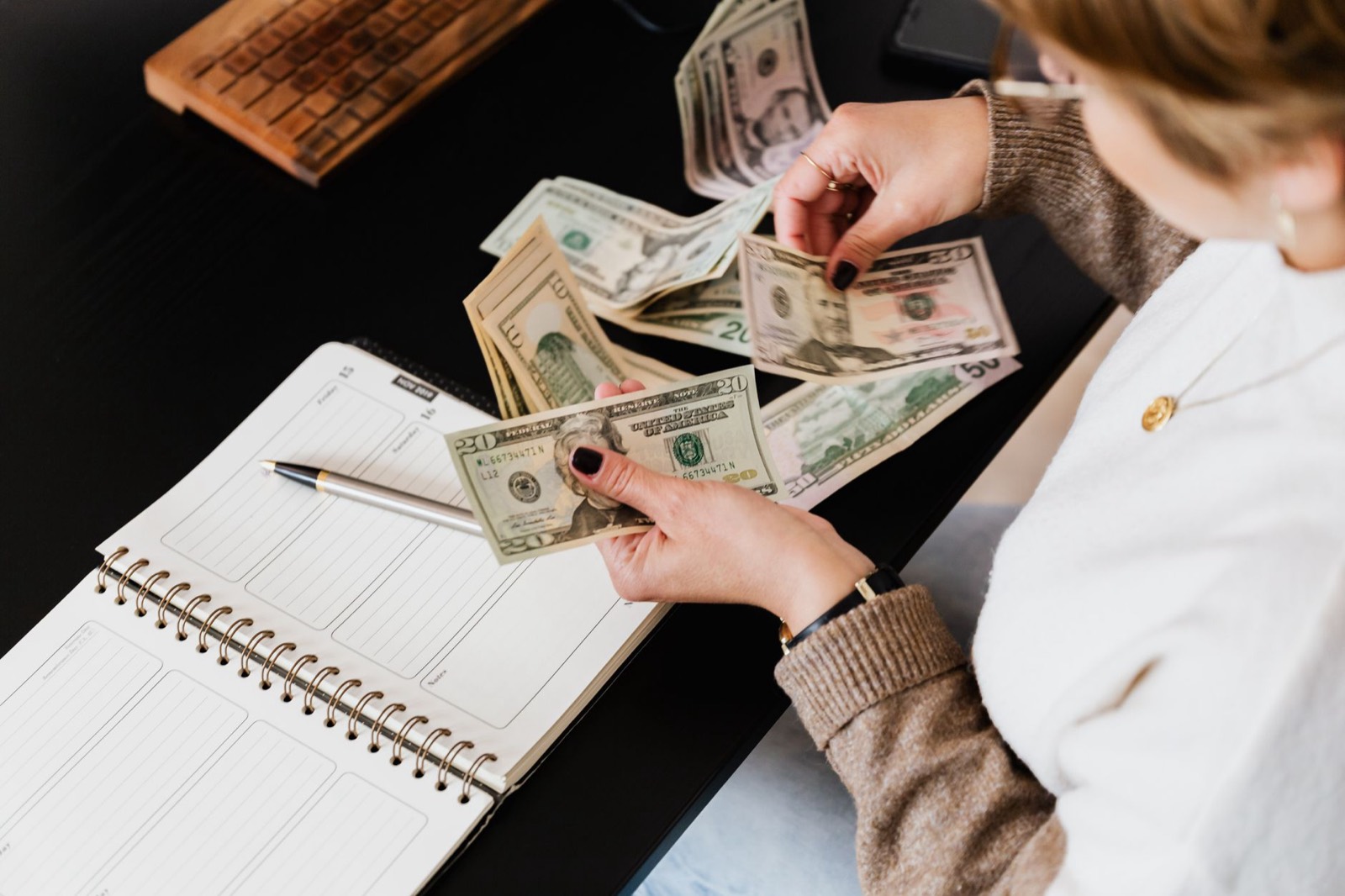 Notebook and planning materials used to set a first apartment furniture budget