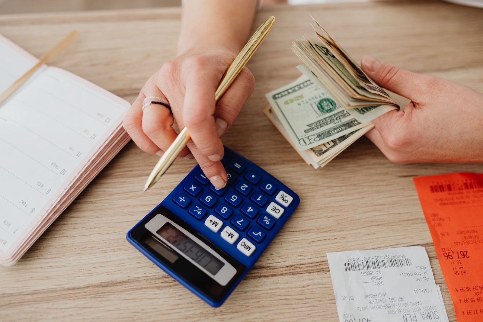 Calculator and paperwork used to compare the total cost of furniture payment plans