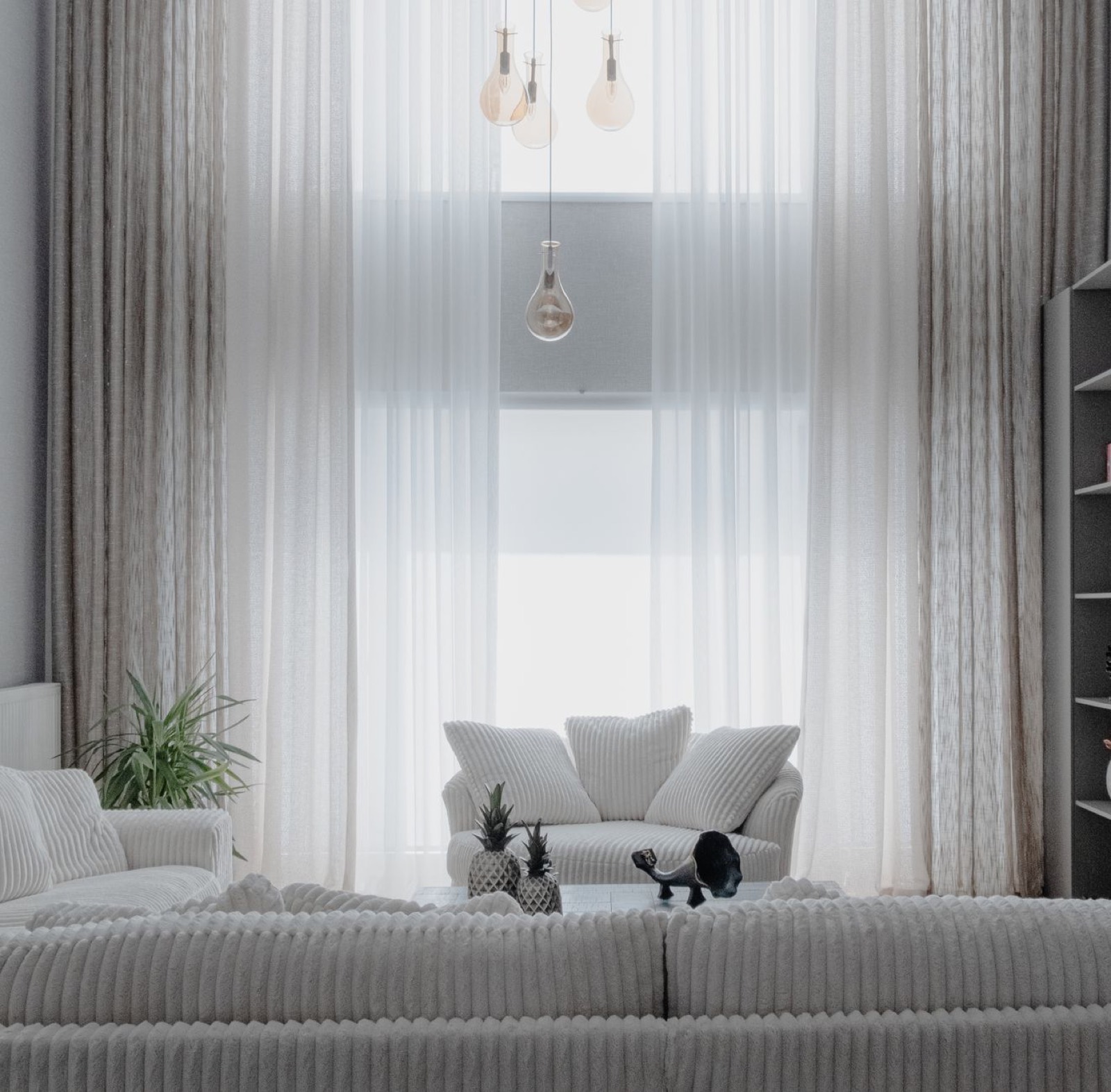 Living room with a sofa positioned against the main wall, showing overall scale and clearance
