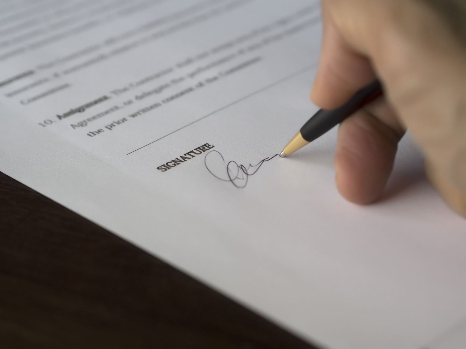 Customer completing a lease-to-own furniture application at a store counter