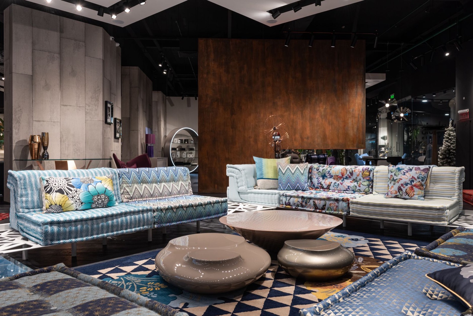 Sofas displayed in a furniture showroom where shoppers can compare sizes and arm styles