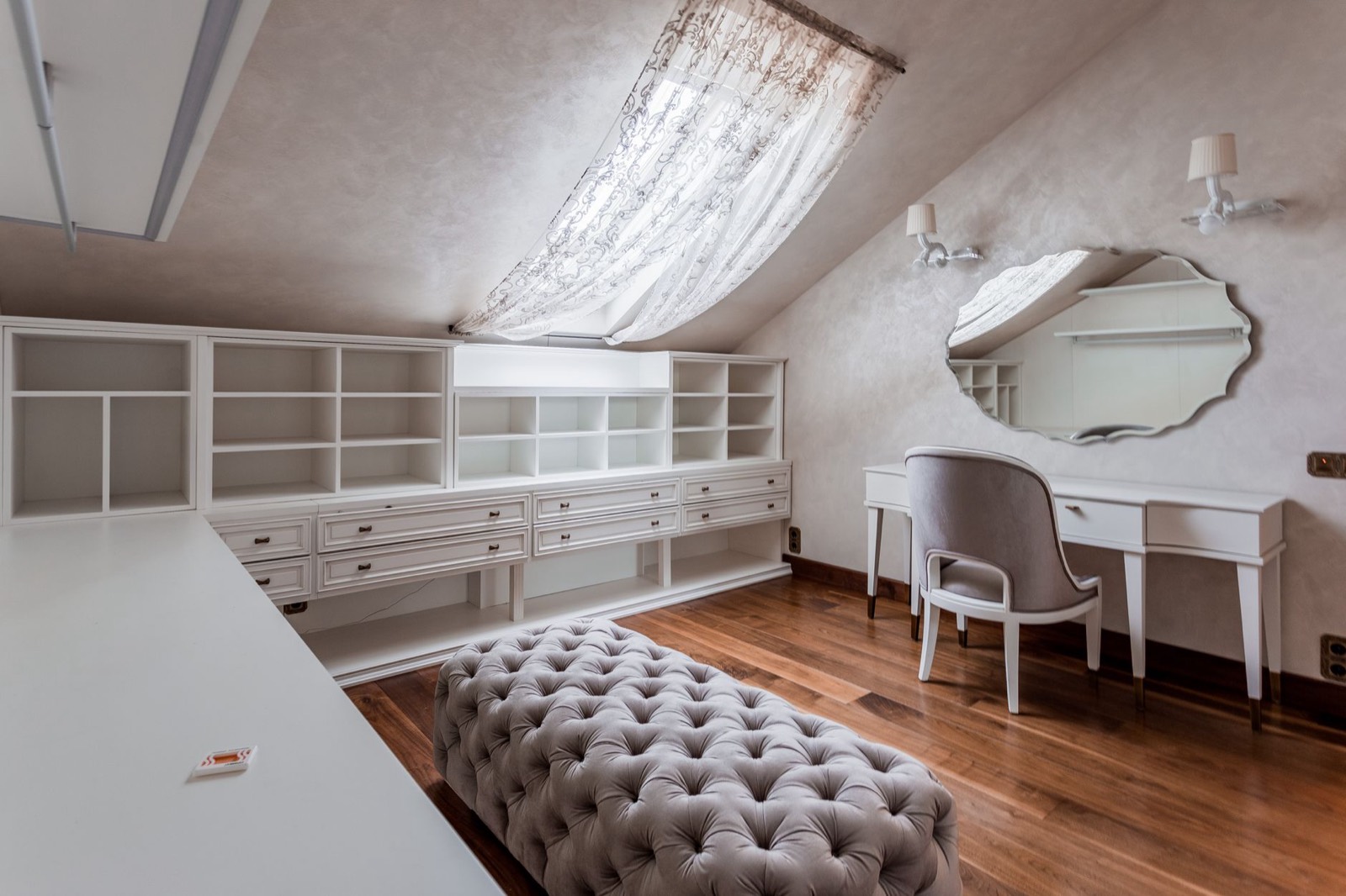 Makeup vanity with mirror set against a bedroom wall in a compact room