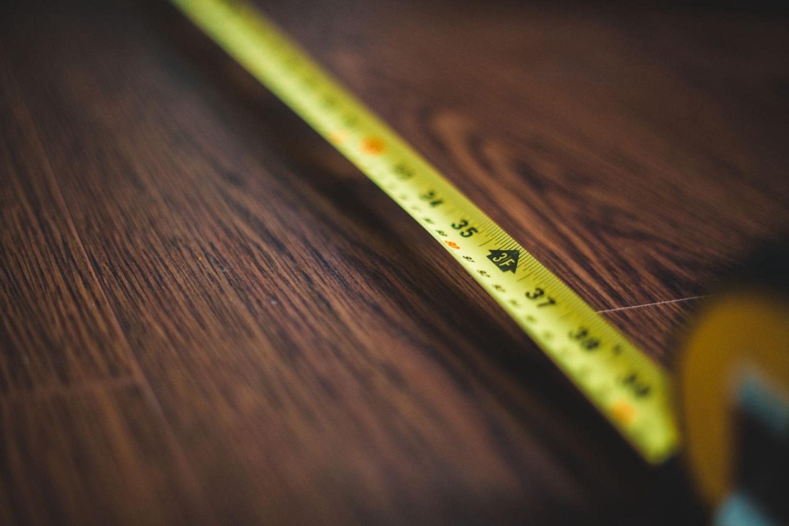Tape measure used to check bedroom floor space before choosing a mattress size
