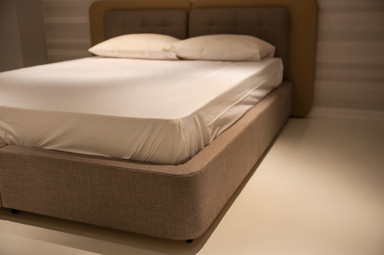 Mattress on a bed frame in a calm bedroom, representing the main mattress construction types