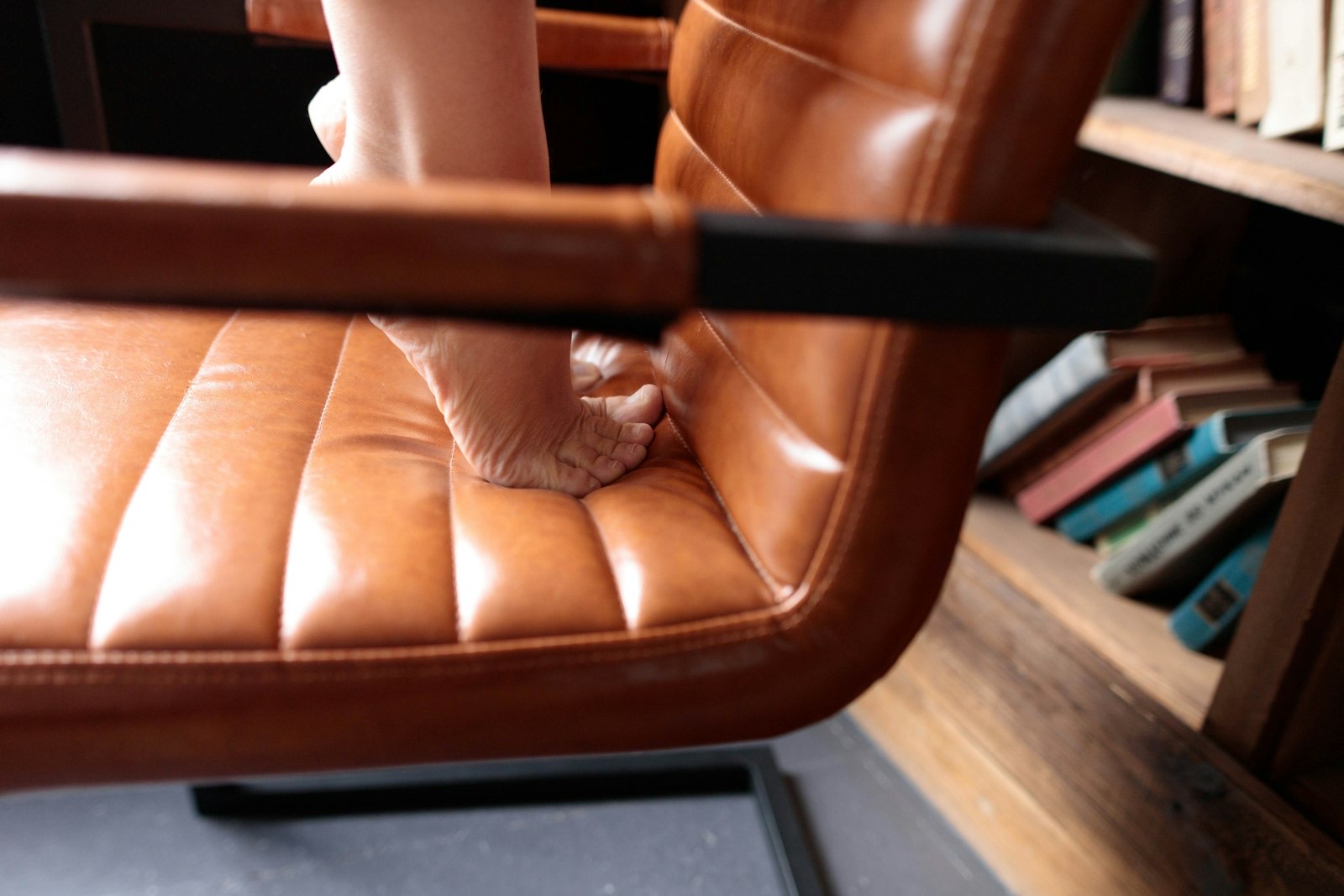 Person reclined with feet up, showing the extended footrest footprint to plan around
