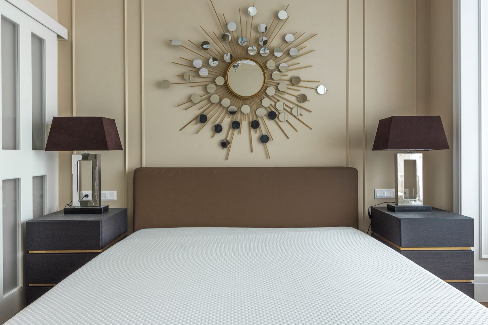 Shopper testing mattress firmness by lying down in a furniture showroom